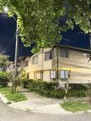 an old building with a tower in the background at Hostal Galería de la Montaña, Medellin in Estación El Salto