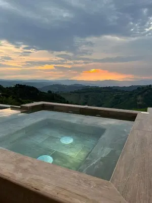 a swimming pool with a view of the mountains at Finca Doña Eva in Manizales