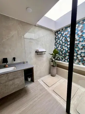a bathroom with a sink and a tub and a plant at Glamping La Nonita tipo cabaña Luxury in Manizales
