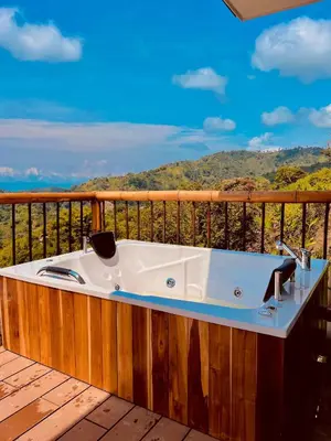 a bath tub sitting on a wooden deck at Glamping La Nonita tipo cabaña Luxury in Manizales