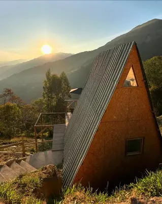a small house with a roof on top of a hill at Chalet Guadalupe - Girardota