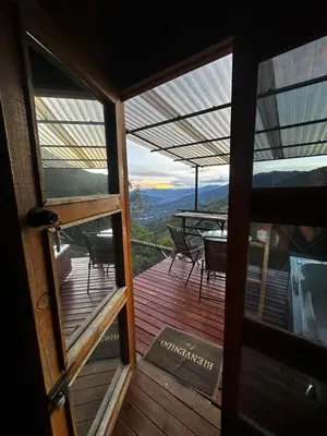 a view of a deck with a table and chairs at Chalet Guadalupe - Girardota
