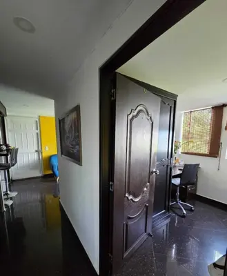 a hallway with a wooden door in a room at Medellin Las Palmas Beautiful View in Medellín