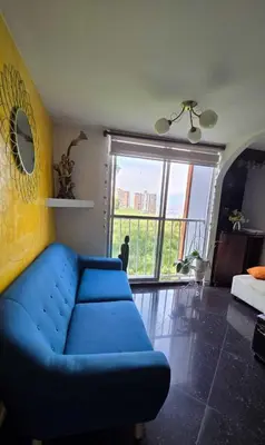 a blue couch in a living room with a large window at Medellin Las Palmas Beautiful View in Medellín