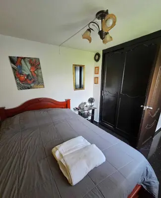 a bedroom with a bed with a towel on it at Medellin Las Palmas Beautiful View in Medellín