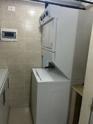 a small kitchen with a white refrigerator with a stove at Apartment in Bello in Medellín