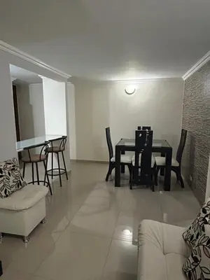 a living room with a dining room table and chairs at Apartment in Bello in Medellín