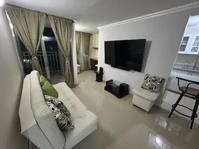 a living room with a white couch and a flat screen tv at Apartment in Bello in Medellín