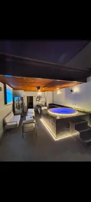 a large living room with couches and a swimming pool at Poblado Luxury Suites in Medellín