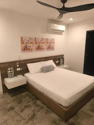 a bedroom with a large bed with a ceiling at Poblado Luxury Suites in Medellín