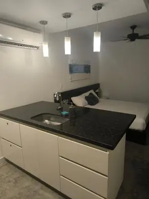a kitchen with a sink and a bed in a room at Poblado Luxury Suites in Medellín