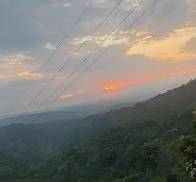 a view of a valley at sunset with power lines at Villa Antonia in Santagueda