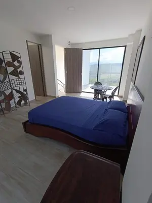 a bedroom with a large blue bed and a balcony at Finca privada Villa Antonia