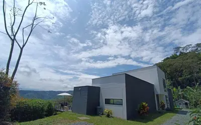 a small building on a hill with a cloudy sky at Finca privada Villa Antonia