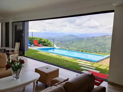 a living room with a view of a swimming pool at Finca privada Villa Antonia