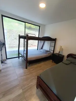 a bedroom with a bunk bed and a large window at Finca privada Villa Antonia