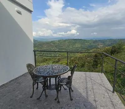 a table and chairs on a balcony with a view at Finca privada Villa Antonia