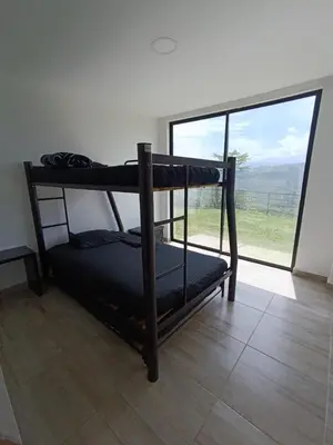 two bunk beds in a room with a large window at Finca privada Villa Antonia