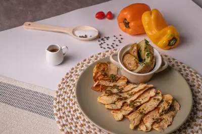 a plate of food with chicken and a bowl of sauce at Ivanna Hotel Campestre - Santa Fe de Antioquia in Santa Fe de Antioquia