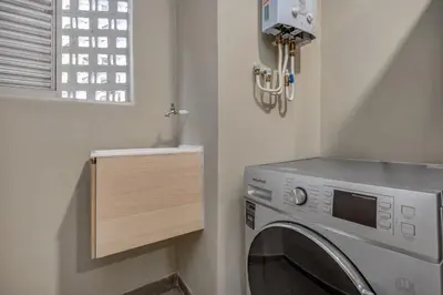 a laundry room with a washing machine and a window at Apartamentos Oslo Tesoro by HOUSY in Medellín