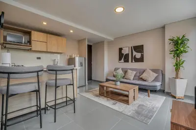 a living room with a couch and a table at Apartamentos Oslo Tesoro by HOUSY in Medellín