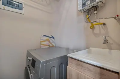 a laundry room with a washing machine and a sink at Apartamentos Oslo Tesoro by HOUSY in Medellín