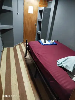a bed in a room with a table and a plate on it at Dulce Hogar Aparta Hotel in Medellín