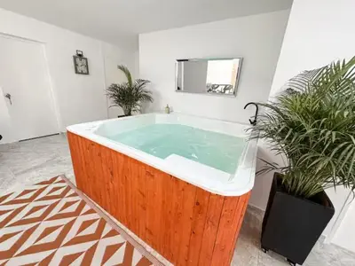 a large bath tub in a room with two potted plants at Casa Lujosa vacacional El Poblado Medellín Por día Con Piscina Jacuzzi AC 9br in Estación El Salto