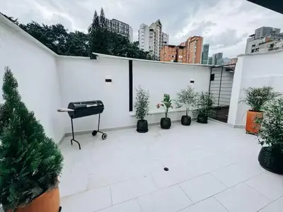 a white patio with potted plants and a piano at Casa Lujosa vacacional El Poblado Medellín Por día Con Piscina Jacuzzi AC 9br in Estación El Salto