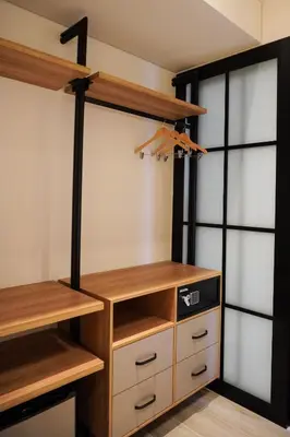 a walk in closet with wooden shelves and cabinets at Hotel Tres Altares Sabaneta in Sabaneta