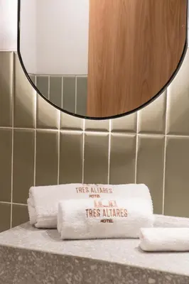 a pile of towels on a counter in a bathroom at Hotel Tres Altares Sabaneta in Sabaneta