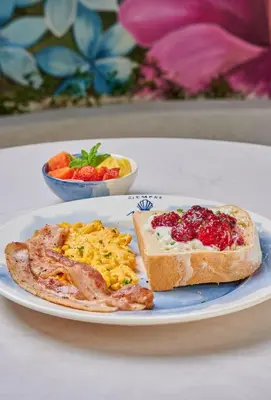 a plate of breakfast food with toast and eggs at Hotel Tres Altares Sabaneta in Sabaneta
