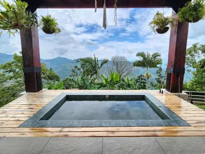 a pool on a deck with a view of the mountains at La mejor vista del eje cafetero en el Chalet La Gitana in Marsella