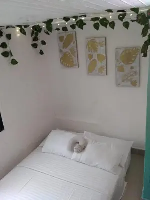 a baby sitting on a bed in a room at DESTINY Apto Parque in San Rafael