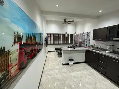 a kitchen with a large painting of a bus on the wall at London suites, By Poblado Suites in Medellín
