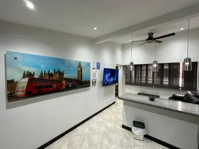 a room with two paintings on the wall at London suites, By Poblado Suites in Medellín
