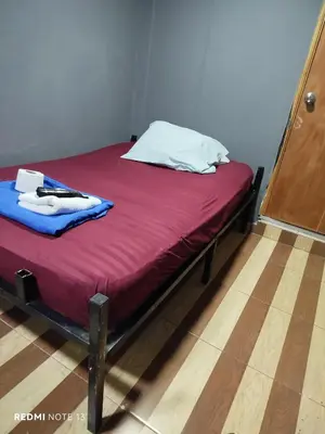 a bed with a red blanket and white pillow on it at Dulce Hogar Aparta Hotel in Medellín