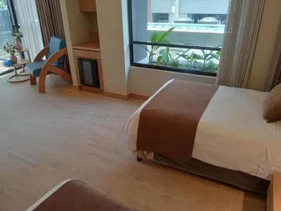 a bedroom with a bed and a view of a balcony at Hotel Rulay Medellin in Medellín