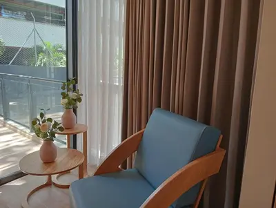 a room with a blue chair and a window at Hotel Rulay Medellin in Medellín