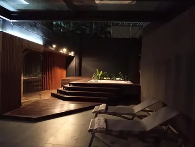 a bathroom with a tub and a chair on a deck at Hotel Rulay Medellin in Medellín