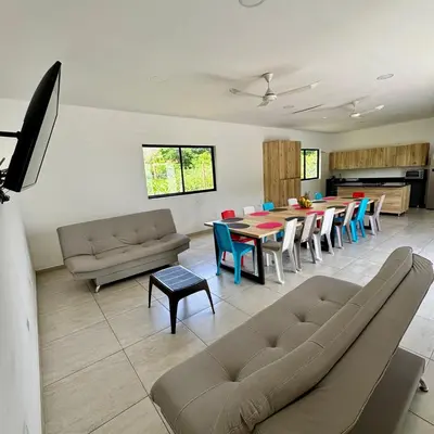 a large living room with a table and chairs at La Mágica Finca en Santa Fe de Antioquia in Santa Fe de Antioquia