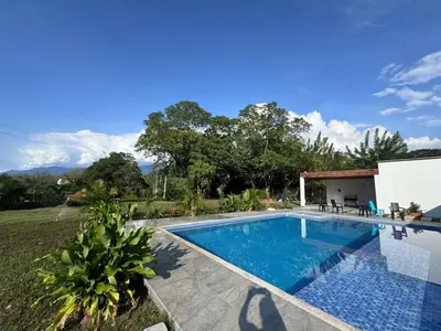 a swimming pool in front of a house at La Mágica Finca en Santa Fe de Antioquia in Santa Fe de Antioquia
