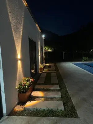 a walkway next to a building at night at La Mágica Finca en Santa Fe de Antioquia in Santa Fe de Antioquia