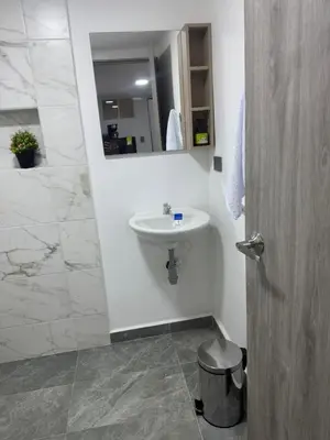 a bathroom with a sink and a mirror at Villa Loreto Aparta estudio 204 in Medellín