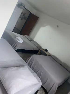 a room with two beds in a room at Hmetrohotel in Medellín