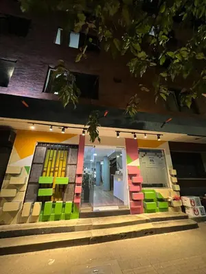 a store front with colorful blocks on the side of a building at Hmetrohotel in Medellín