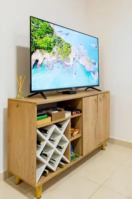 a flat screen tv on a wooden entertainment center at Apartamento San Jerónimo - Antioquia in San Jerónimo