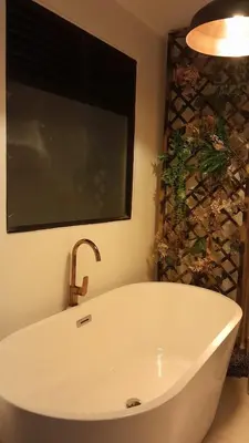 a bath tub with a faucet in a bathroom at Espectacular apartamento completamente dotado en Yarumal Antioquia! in Estación El Salto