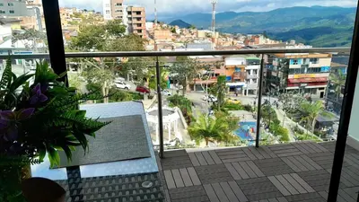 a balcony with a bench and a view of a city at Espectacular apartamento completamente dotado en Yarumal Antioquia! in Estación El Salto
