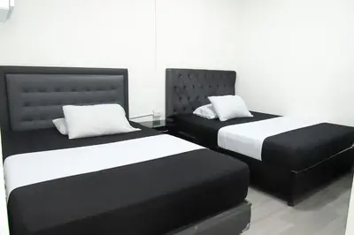 two beds sitting next to each other in a room at El ensueño in Manizales